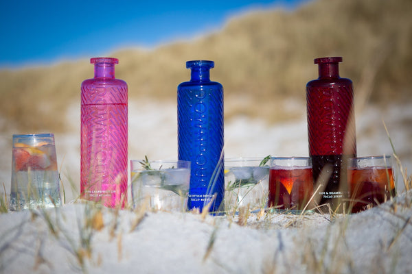 3  bottles of Downpour Gin on the Beach