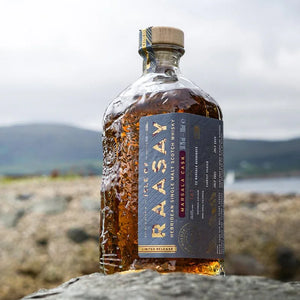 Isle of Raasay Marsala Cask single malt scotch whisky bottle outdoors on rocky surface