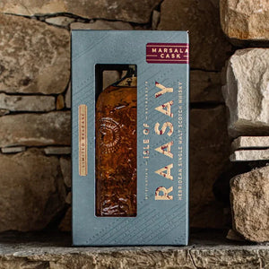 Isle of Raasay Marsala Cask single malt Scotch whisky in blue gift box against stone wall