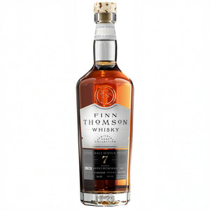 A bottle of Finn Thomson Whisky on a plain white background. The bottle is filled with amber-colored whisky and features a white and dark gray label with the brand name 'Finn Thomson Whisky' clearly visible.